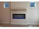 Modern living room featuring an electric fireplace, white walls, and wooden floors at 14 Relaxing Way, Pittsboro, NC 27312
