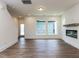 Living room with hardwood floors, fireplace, and access to the staircase and backyard at 14 Relaxing Way, Pittsboro, NC 27312