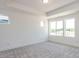 Spacious bedroom featuring tray ceiling, neutral walls, and a wall of bright windows at 14 Relaxing Way, Pittsboro, NC 27312