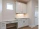 Bright office nook features white cabinets, drawers, and countertops, plus a window for natural light at 14 Relaxing Way, Pittsboro, NC 27312