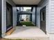 Open patio area with black framed doors, view of the green lawn, and the home's light gray siding at 14 Relaxing Way, Pittsboro, NC 27312