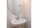 Elegant powder room features a pedestal sink, round mirror, and modern fixtures at 14 Relaxing Way, Pittsboro, NC 27312