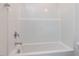 Shower and tub combo featuring white tile walls with chrome hardware at 14 Relaxing Way, Pittsboro, NC 27312