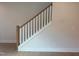Staircase featuring white painted wood and light colored hardwood floors at 14 Relaxing Way, Pittsboro, NC 27312