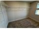 Walk-in closet featuring carpet and wire shelving for organized storage and natural light from a window at 14 Relaxing Way, Pittsboro, NC 27312