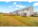 Large backyard featuring a well-maintained lawn, partial fence, and trampoline at 1427 Carisbrooke Dr, Mebane, NC 27302