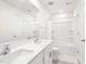 Pristine bathroom featuring a double vanity, a bathtub-shower, and bright, all-white finishes at 1427 Carisbrooke Dr, Mebane, NC 27302