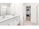 Bathroom featuring double sinks with white cabinets, tile flooring, and a glass shower at 1427 Carisbrooke Dr, Mebane, NC 27302