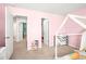 Well-lit bedroom with pink walls, carpeted floors, and multiple entryways for convenience at 1427 Carisbrooke Dr, Mebane, NC 27302