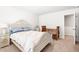 Serene bedroom with a wicker bed frame, natural light, and a tranquil, inviting ambiance at 1427 Carisbrooke Dr, Mebane, NC 27302
