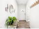 Welcoming entryway with hardwood floors, a decorative mirror, a wooden console table, and a front door wreath at 1427 Carisbrooke Dr, Mebane, NC 27302