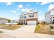 Charming two-story home with a brick and vinyl exterior, attached two-car garage, and front yard at 1427 Carisbrooke Dr, Mebane, NC 27302