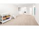 Spacious hallway featuring neutral carpet, white walls, and ample natural light at 1427 Carisbrooke Dr, Mebane, NC 27302