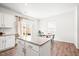 Open kitchen with granite counters, eat-in dining, and bright, natural light at 1427 Carisbrooke Dr, Mebane, NC 27302