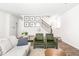 Cozy living area showcasing comfortable seating and view of the staircase at 1427 Carisbrooke Dr, Mebane, NC 27302