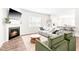 Well-lit living space with a fireplace, comfortable seating, and adjacent kitchen at 1427 Carisbrooke Dr, Mebane, NC 27302
