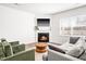 Comfortable living room features a fireplace, a large window and modern decor at 1427 Carisbrooke Dr, Mebane, NC 27302