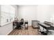 Bright home office with wood floors, a modern desk, and a large window for ample natural light at 1427 Carisbrooke Dr, Mebane, NC 27302