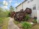 Backyard featuring a lush garden, inviting walkway, and multiple decks for outdoor enjoyment at 14315 Foxcroft Rd, Raleigh, NC 27614