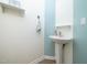 Charming powder room featuring a pedestal sink, decorative shelves, and stylish wall accents at 14315 Foxcroft Rd, Raleigh, NC 27614