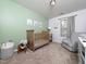 Welcoming bedroom with soft green accent wall, crib, and comfortable seating area at 14315 Foxcroft Rd, Raleigh, NC 27614