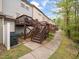 Townhome exterior featuring multiple decks, lush landscaping and a convenient walkway at 14315 Foxcroft Rd, Raleigh, NC 27614
