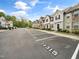 Exterior street view of the townhome community with assigned, numbered parking spaces and mature trees at 14315 Foxcroft Rd, Raleigh, NC 27614