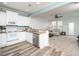 Open concept kitchen featuring white cabinetry, stainless steel appliances, and views into the living area at 14315 Foxcroft Rd, Raleigh, NC 27614