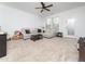 Relaxing living room with a large sectional, soft carpet, and a bright window view at 14315 Foxcroft Rd, Raleigh, NC 27614