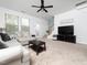 Spacious living room with plush seating, a mounted television, and a neutral decor at 14315 Foxcroft Rd, Raleigh, NC 27614