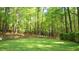 Lush backyard with a fire pit and tree coverage at 1505 Sharnbrook Ct, Raleigh, NC 27614