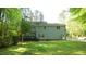 Expansive backyard view featuring a well-maintained lawn, a deck perfect for outdoor seating, and mature trees at 1505 Sharnbrook Ct, Raleigh, NC 27614