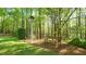 The well-maintained backyard has a birdhouse and a bench at 1505 Sharnbrook Ct, Raleigh, NC 27614