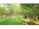 Expansive backyard featuring lush greenery, mature trees, and charming seating areas perfect for relaxation and outdoor enjoyment at 1505 Sharnbrook Ct, Raleigh, NC 27614