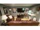 Finished basement with a cozy sitting area, wet bar, entertainment center, and comfortable leather furniture at 1505 Sharnbrook Ct, Raleigh, NC 27614
