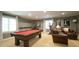 Finished basement featuring a pool table, exercise equipment, movie posters, and seating area by windows at 1505 Sharnbrook Ct, Raleigh, NC 27614