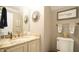 Bathroom with granite countertop, framed mirror and 'Choose Happy' sign for a warm, inviting feeling at 1505 Sharnbrook Ct, Raleigh, NC 27614