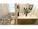 Bathroom featuring double sink vanity, framed mirror, and tile floors at 1505 Sharnbrook Ct, Raleigh, NC 27614