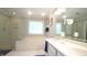 Bright bathroom featuring double vanity, soaking tub, glass enclosed shower, and tile floors at 1505 Sharnbrook Ct, Raleigh, NC 27614