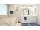 Bright bathroom featuring double vanity, soaking tub, framed mirrors, and neutral paint at 1505 Sharnbrook Ct, Raleigh, NC 27614