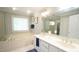 Bright bathroom featuring a double vanity, bathtub, and natural light, providing a serene and functional space at 1505 Sharnbrook Ct, Raleigh, NC 27614