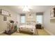 Cozy bedroom featuring neutral walls, ceiling fan, two windows, and matching dog-themed decor at 1505 Sharnbrook Ct, Raleigh, NC 27614