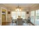 Bright dining room with a modern chandelier and ample natural light at 1505 Sharnbrook Ct, Raleigh, NC 27614
