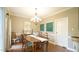 Elegant dining area featuring hardwood floors, a chandelier, and comfortable seating for Gathering and guests at 1505 Sharnbrook Ct, Raleigh, NC 27614