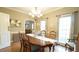 Charming dining room with hardwood floors, chandelier, and large table, ideal for Gathering gatherings at 1505 Sharnbrook Ct, Raleigh, NC 27614