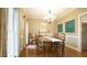 Formal dining room with a wooden table, elegant chandelier, and decorative artwork at 1505 Sharnbrook Ct, Raleigh, NC 27614