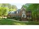 Beautiful brick home surrounded by lush trees and landscaping, offering a serene and inviting setting at 1505 Sharnbrook Ct, Raleigh, NC 27614