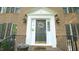 Elegant front entrance with decorative wreath, sidelights, and a charming brick walkway at 1505 Sharnbrook Ct, Raleigh, NC 27614