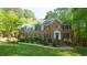 Traditional two-story brick home featuring manicured landscaping, and a welcoming front entrance at 1505 Sharnbrook Ct, Raleigh, NC 27614