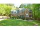 Charming two-story brick home featuring a meticulously landscaped front yard and inviting entrance at 1505 Sharnbrook Ct, Raleigh, NC 27614